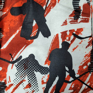 Hockey-themed fabric with black silhouettes of hockey players on a red and white background
